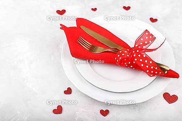 Romantic table setting on white stone table. Valentine's day card template [IBR124084188]