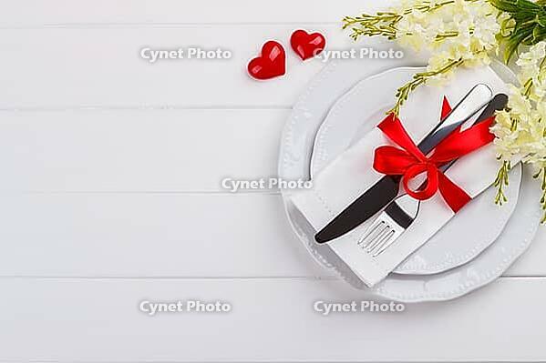 Romantic table setting on white wooden table.Valentine's day card template [IBR124084189]