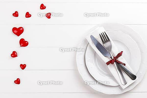 Romantic table setting on white wooden table.Valentine's day card template [IBR124084190]