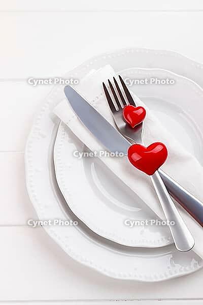 Romantic table setting on white wooden table.Valentine's day card template [IBR124084191]