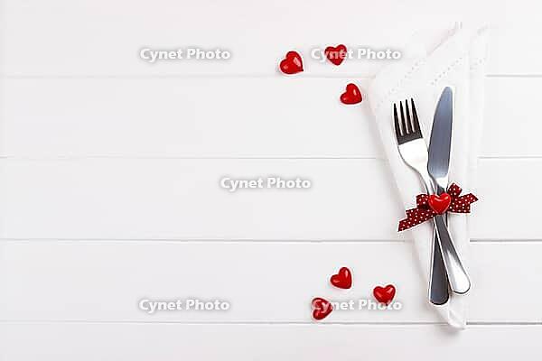Romantic table setting on white wooden table.Valentine's day card template [IBR124084193]