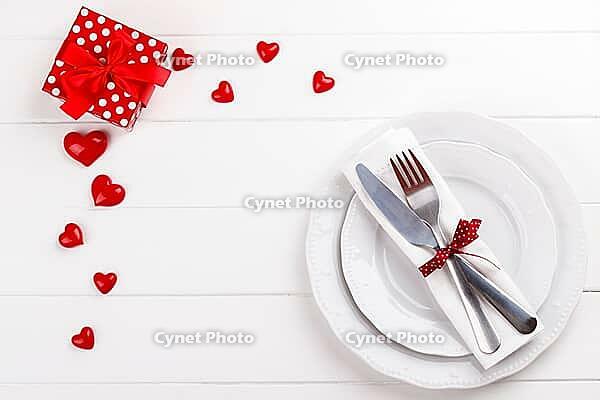 Romantic table setting on white wooden table.Valentine's day card template [IBR124084194]