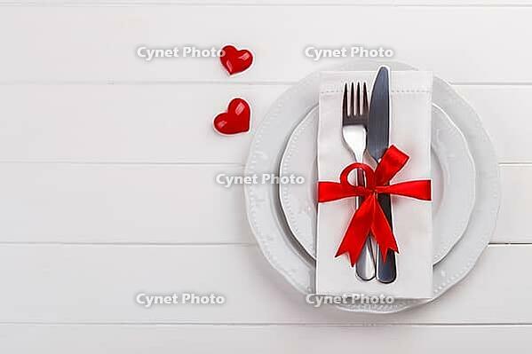 Romantic table setting on white wooden table.Valentine's day card template [IBR124084195]