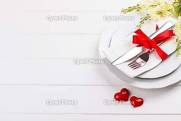 Romantic table setting on white wooden table.Valentine's day card template [IBR124084196]