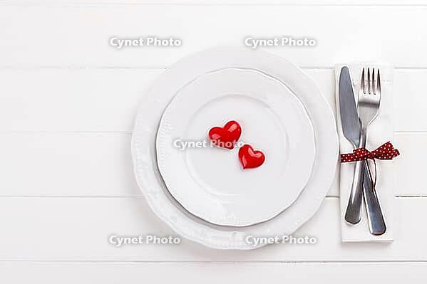 Romantic table setting on white wooden table.Valentine's day card template [IBR124084197]