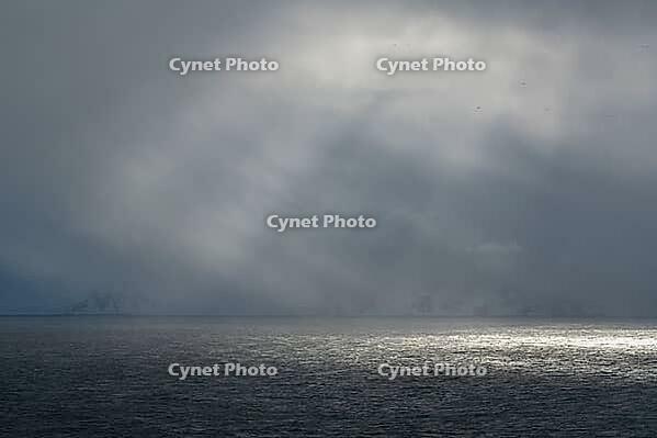 Dramatic lighting over the Norwegian European Sea, Söröya, Finnmark, Norway, March 2019 [IBR124200494]