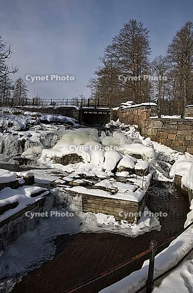 The ruins of the historic Borgvik Ironworks. Industrial stone architecture on a river in winter with snow and blue skies. Cultural heritage site in picturesque countryside in Värmland, Sweden [IBR124200526]