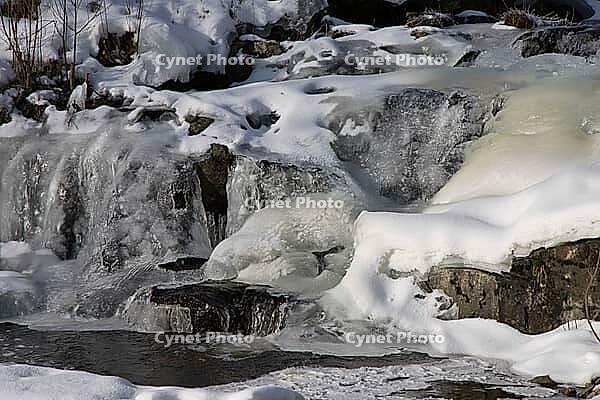 The ruins of the historic Borgvik Ironworks. Industrial stone architecture on a river in winter with snow and blue skies. Cultural heritage site in picturesque countryside in Värmland, Sweden [IBR124200532]
