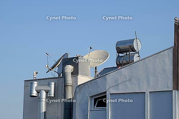 Steel barrels of boilers with water on the roof of a building to heat water. Water heating by the sun and solar panels. Antalya, Turkey [IBR124200538]