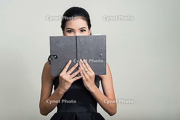 Studio shot of young beautiful Asian businesswoman against white background [IBR124308999]