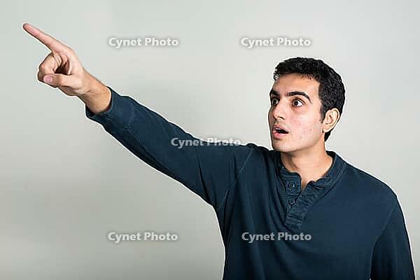 Studio shot of young handsome Indian man against white background [IBR124309000]
