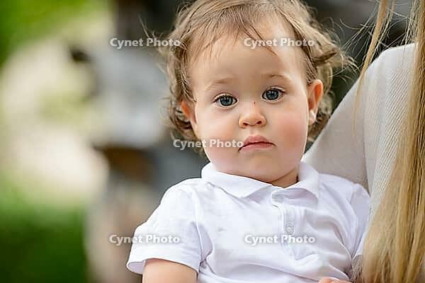 Portrait of young adorable baby boy with curly blond hair [IBR124309011]