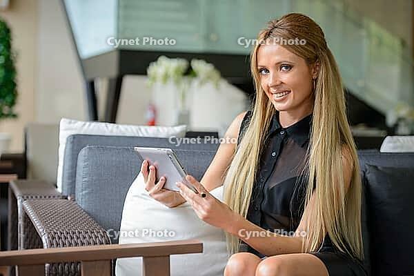 Portrait of young beautiful businesswoman with blond hair indoors [IBR124309013]