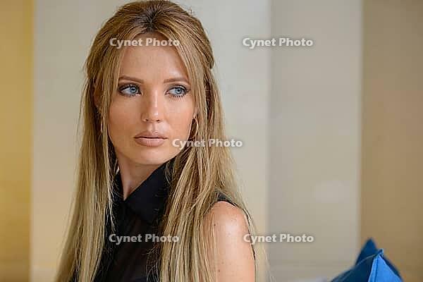 Portrait of young beautiful businesswoman with blond hair indoors [IBR124309022]