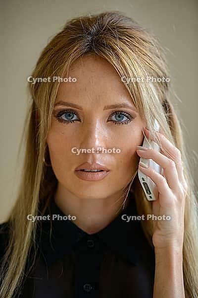 Portrait of young beautiful businesswoman with blond hair indoors [IBR124309023]