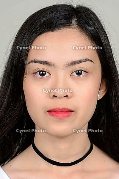 Studio shot of young beautiful Asian woman against white background [IBR124309025]