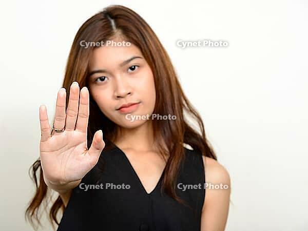 Studio shot of young beautiful Asian woman against white background [IBR124309028]