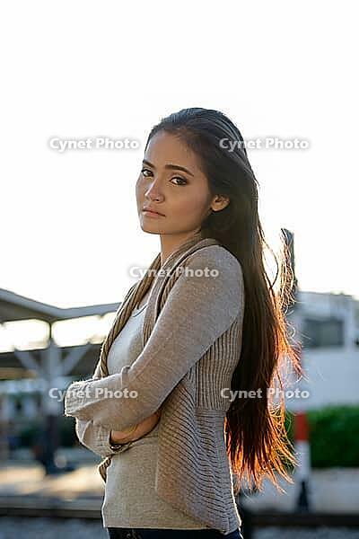 Portrait of young beautiful Asian woman at the railway station [IBR124309029]