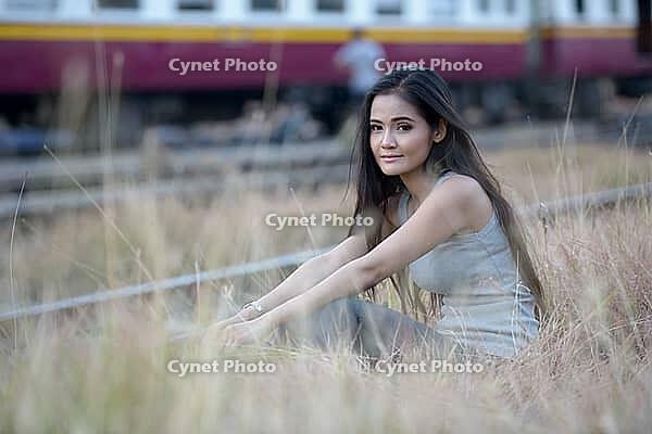Portrait of young beautiful Asian woman at the railway station [IBR124309030]