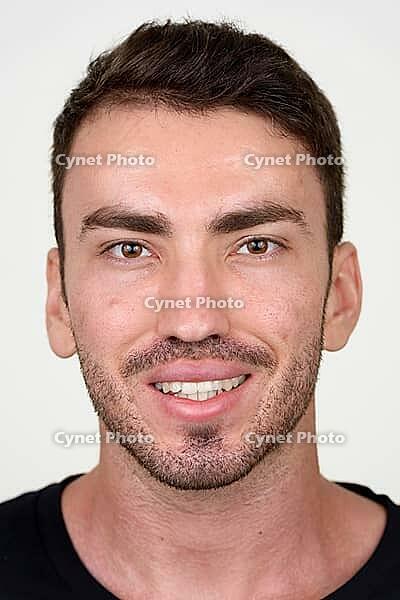Studio shot of handsome bearded Persian man against white background [IBR124309040]
