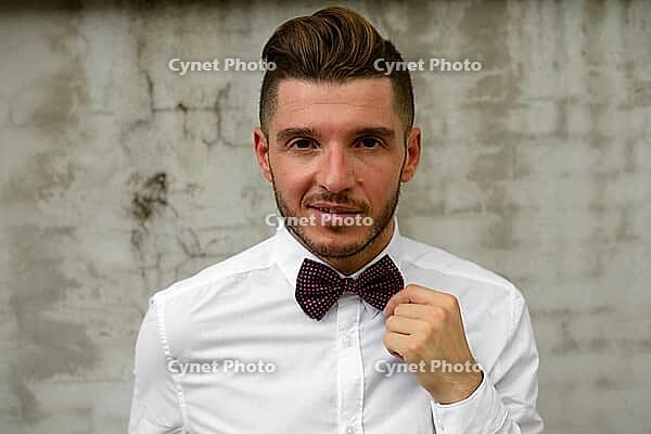 Portrait of handsome bearded Hispanic businessman in the streets outdoors [IBR124309048]