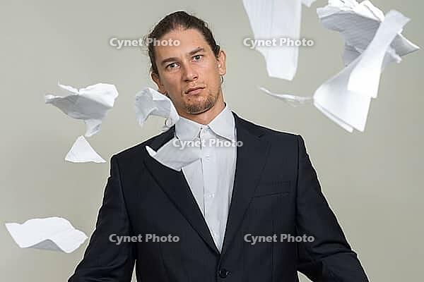Studio shot of handsome bearded businessman with long hair against white background [IBR124309051]