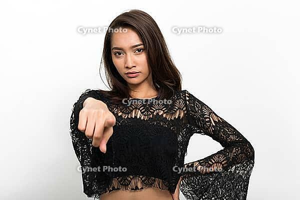 Studio shot of young beautiful Asian woman against white background [IBR124309060]