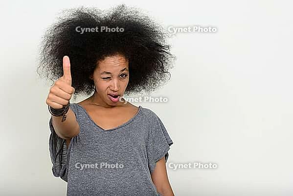 Studio shot of young beautiful African woman with Afro hair against white background [IBR124309066]