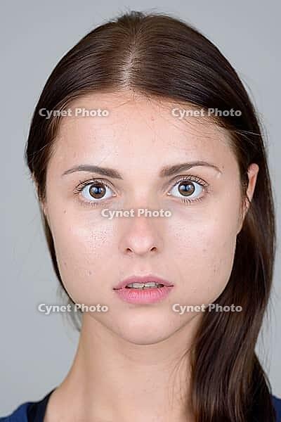Studio shot of young beautiful woman against white background [IBR124309067]