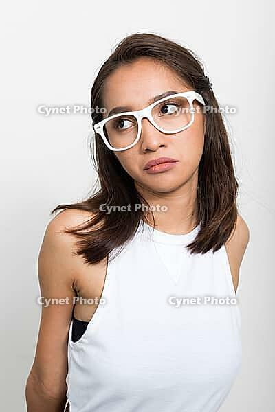 Studio shot of young beautiful Asian woman against white background [IBR124309069]