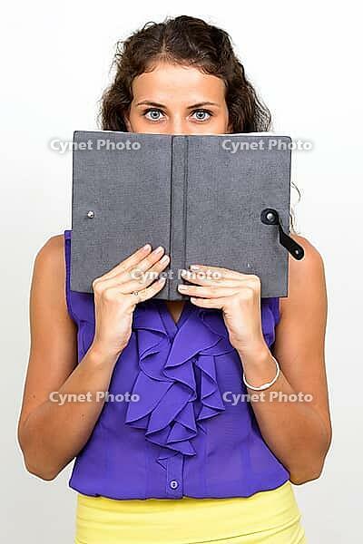Studio shot of young beautiful businesswoman with curly hair against white background [IBR124309071]
