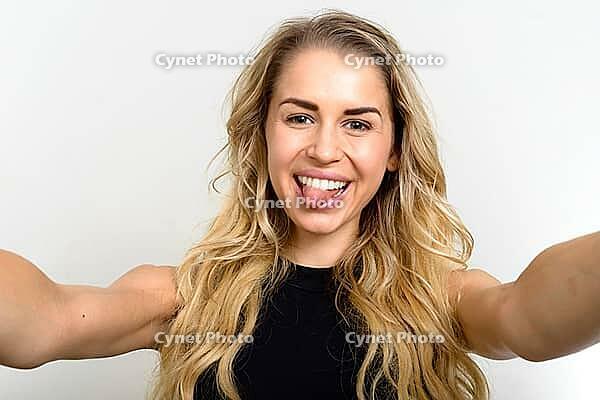 Studio shot of young beautiful woman with blonde wavy hair against white background [IBR124309073]