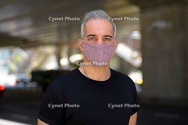Portrait of Persian man with mask for protection from corona virus outbreak and pollution in the city streets outdoors [IBR124309078]
