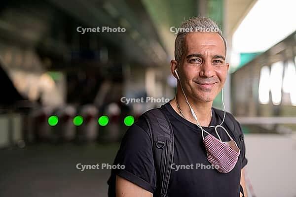 Portrait of Persian man with mask for protection from corona virus outbreak and pollution at the sky train station [IBR124309080]