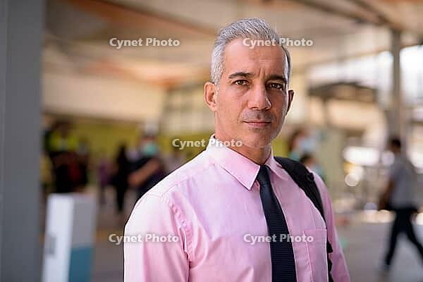 Portrait of handsome Persian businessman with gray hair at the sky train station [IBR124309085]