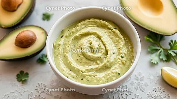 Creamy avocado dip in a white bowl surrounded by avocados and herbs, delicious dip, perfect as a side dish for meals and parties, AI generates, AI generated [IBR124458860]