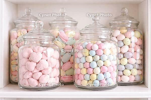 Pastel-colored candies stacked on a shelf in clear glass containers, pastel-colored candy, AI generated [IBR124458861]