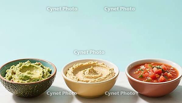 Three different dips in bowls: avocado, hummus and salsa, on a light background, delicious dip, perfect as a side dish for meals and parties, AI generates, AI generated [IBR124458885]
