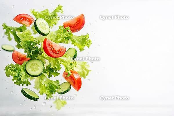 Fresh lettuce leaves, tomatoes and cucumbers float in the air, healthy food, AI generates, AI generated [IBR124458886]