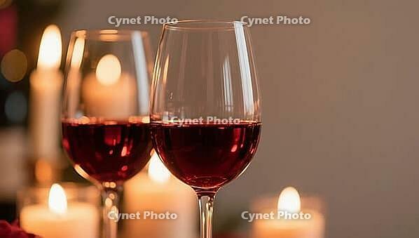 Two candlelit wine glasses in a warm, intimate atmosphere, AI generated [IBR124458898]