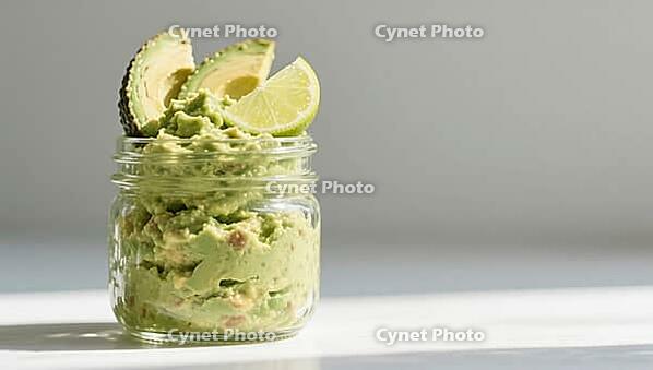 Guacamole in a glass, garnished with avocado and lime slices, on a bright table, delicious dip, perfect as a side dish for meals and parties, AI generates, AI generated [IBR124458913]