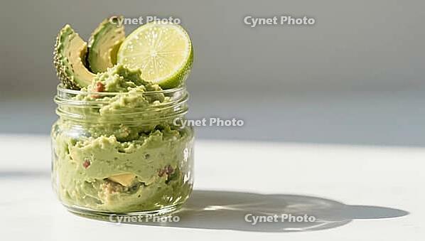 Creamy guacamole in a glass, garnished with lime slices, with shade on the table, delicious dip, perfect as a side dish for meals and parties, AI generates, AI generated [IBR124458916]