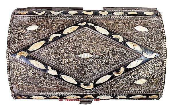 View from above of a traditional old Arab coffin decorated with incrustations against a white background [IBR124458919]