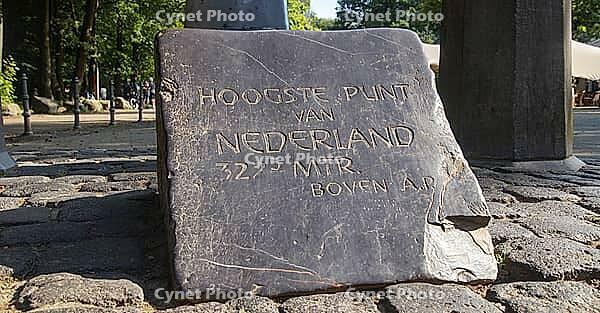 Stone with engraving marks the highest point in the Netherlands, surrounded by paving stones, border triangle, Germany, Netherlands, Belgium [IBR124491553]