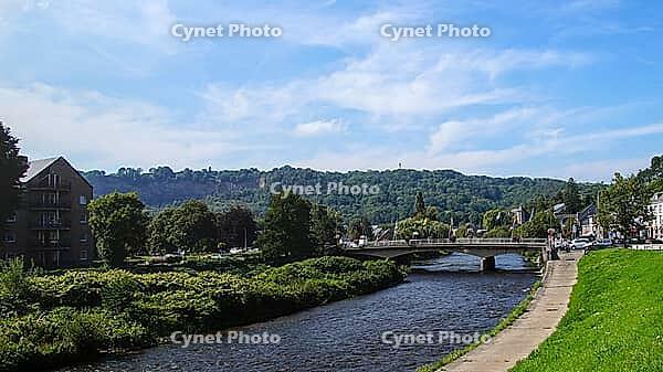River under a bridge surrounded by lush greenery and hills, quiet summer atmosphere, Aywaille, Belgium [IBR124491606]