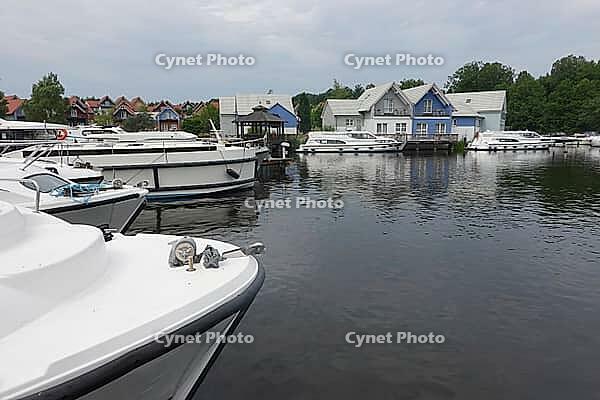 Charter boats and holiday homes in Marina Wolfsbruch, Rheinsberg, Brandenburg, Germany [IBR124494870]