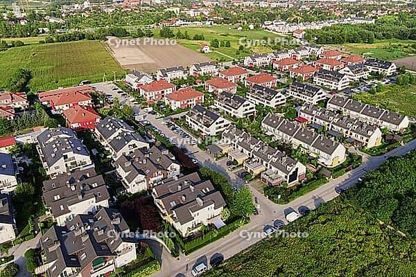 Aerial view of suburban neighborhood, Residential district with houses and streets in small european town [IBR124497451]