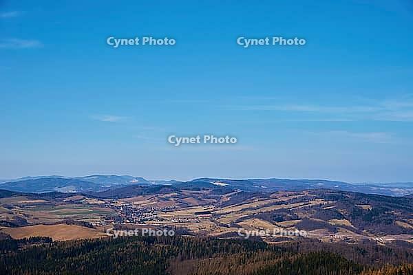 Beautiful mountains covered with evergreen forest on sunny day. Natural landscape with mountain ranges and valleys [IBR124497472]