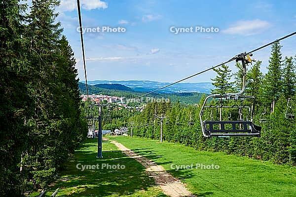 Beautiful mountains, covered with forest and open cable car line. Karpacz resort in Poland with lift road. Family outdoor recreation in mountains [IBR124497486]