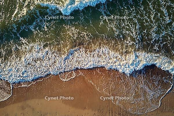 Sand beach with sea waves, top view. Summer vacation and travel concept. Beautiful coastline with baltic sea and sand beach, aerial view [IBR124497499]